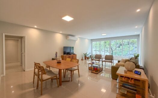 Renovated Copacabana three-bedroom – living and dining room with wall-to-wall windows